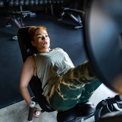determined-woman-working-out-on-leg-press-machine-2025-03-08-23-32-44-utc