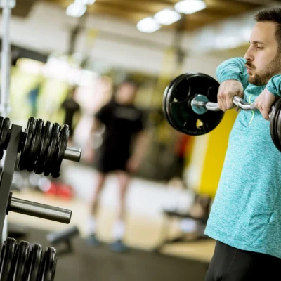 handsome-young-man-uses-dumbbells-in-gym-2025-02-21-21-52-55-utc